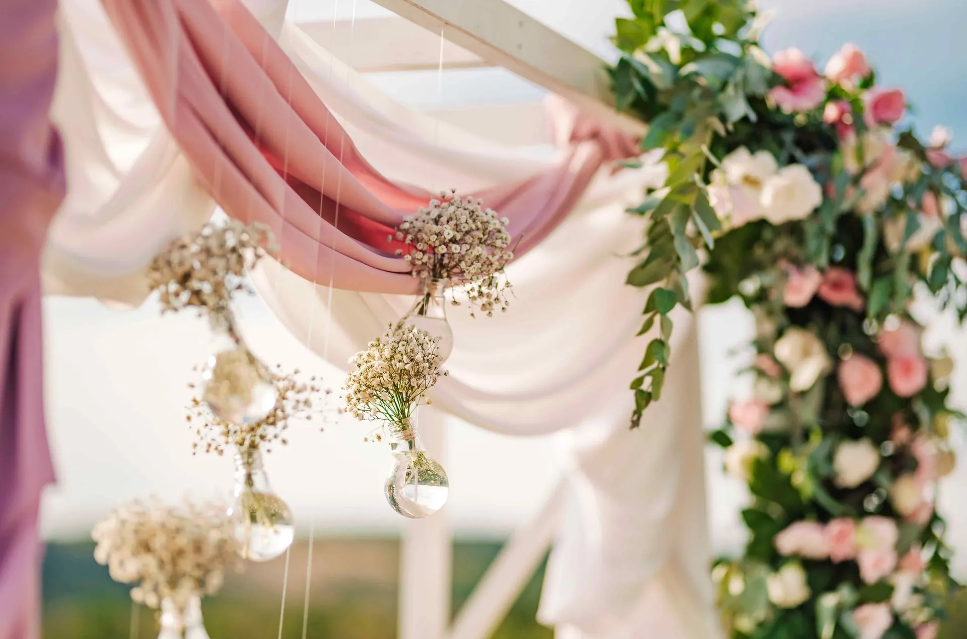 Floral arch and soft draping set up for an engagement party at the farm